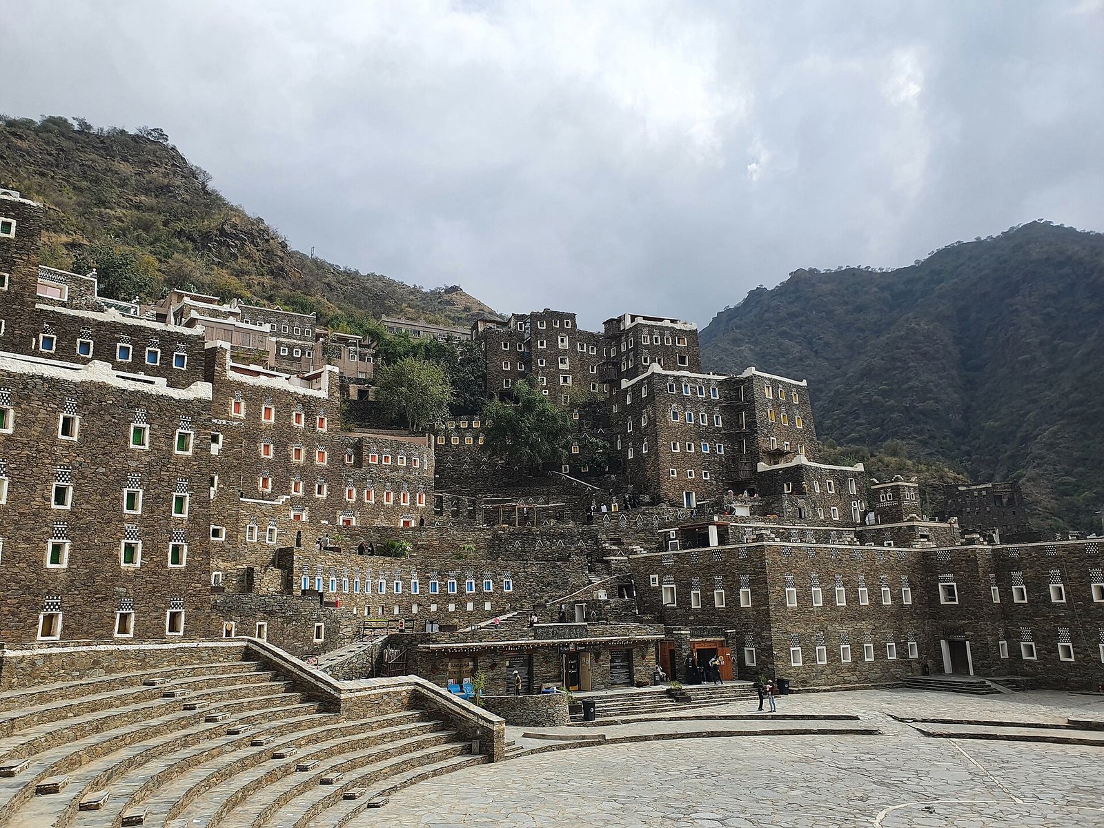 The stone tower houses of Rijal Almaa village rising against the green Asir mountains