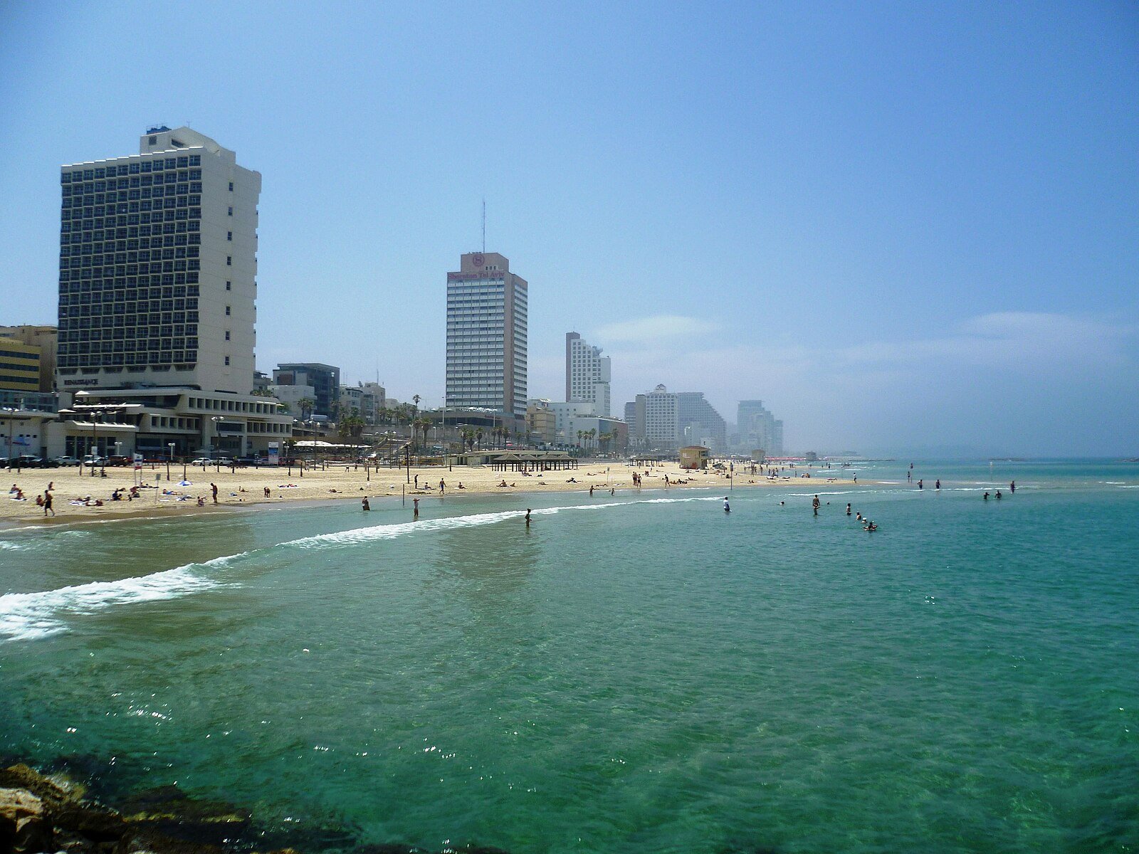Beachfront hotel towers above the turquoise Mediterranean and the sands of Tel Aviv.