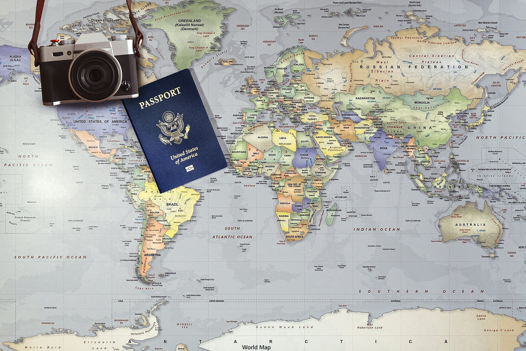A passport and a camera on a world map