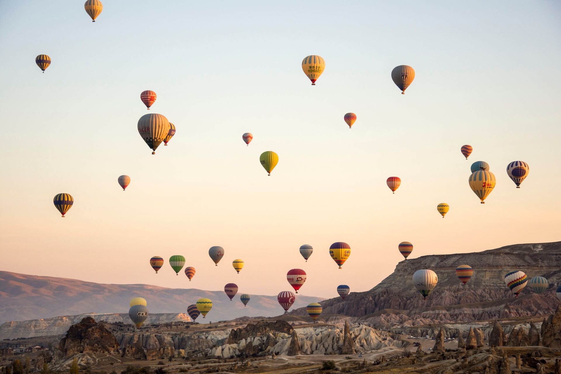 Hot-air balloons rising over the valleys of Cappadocia at dawn