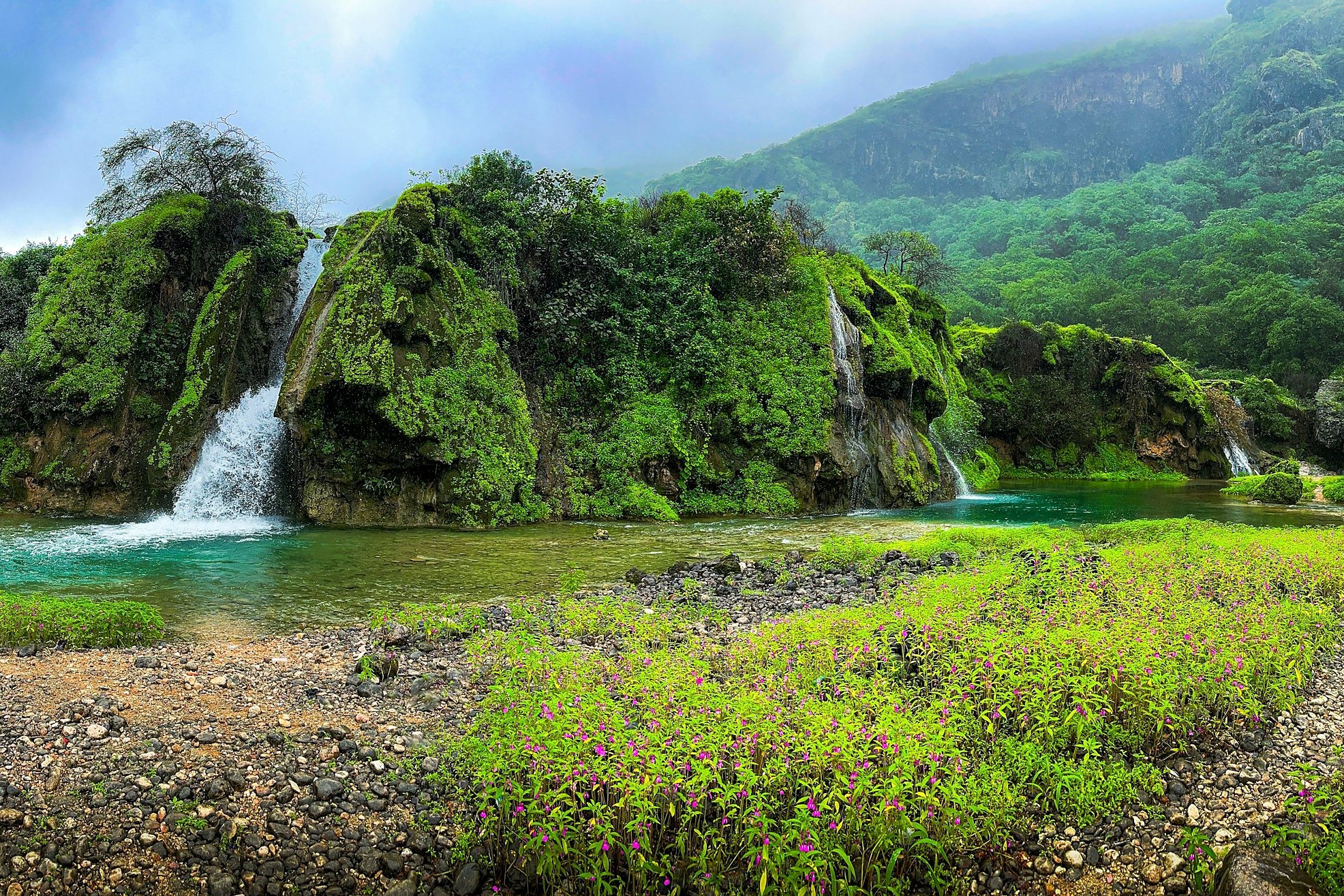 Waterfalls and green hills in the khareef season near Salalah, Oman