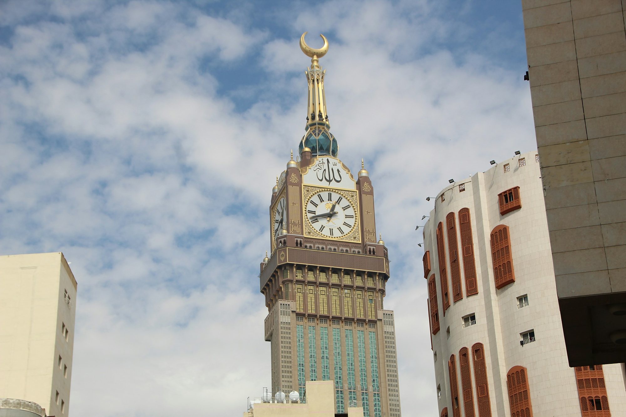 The Makkah Clock Tower against a sky of white cloud