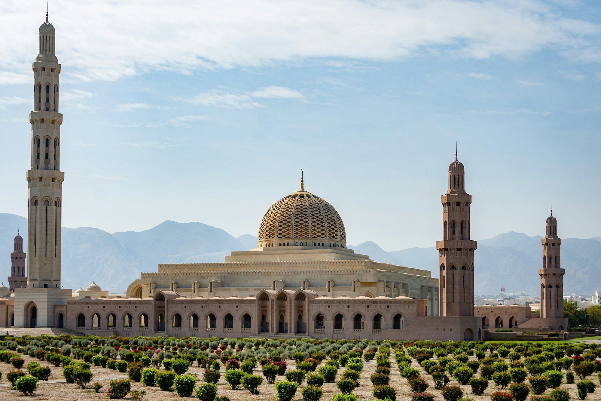 The Sultan Qaboos Grand Mosque in Muscat with the Hajar Mountains