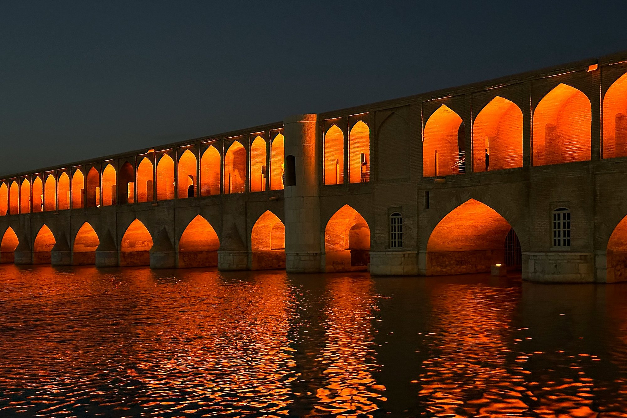 The arches of Si-o-se-pol glowing over the river in Isfahan