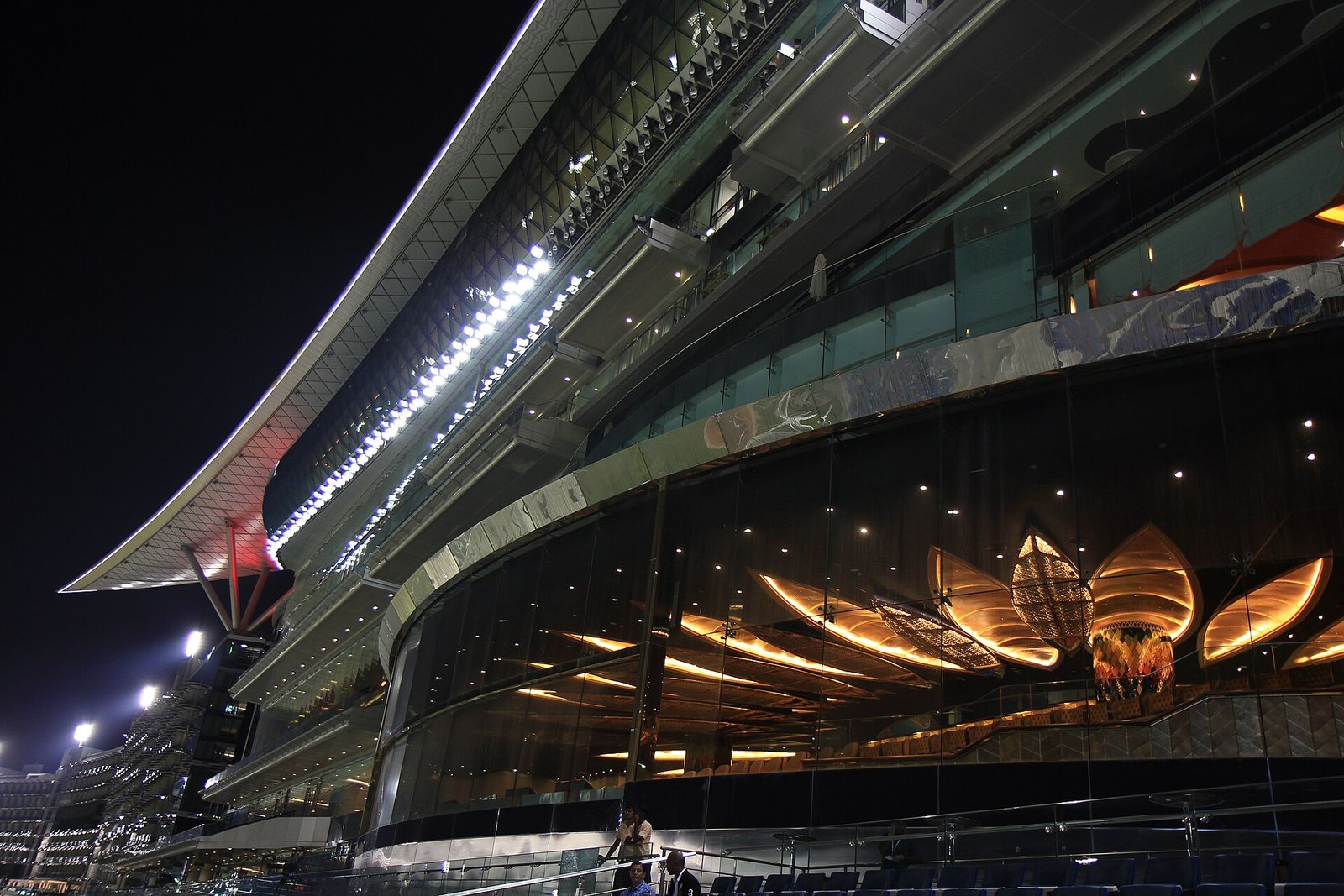 The sweeping illuminated grandstand of Meydan Racecourse in Dubai at night