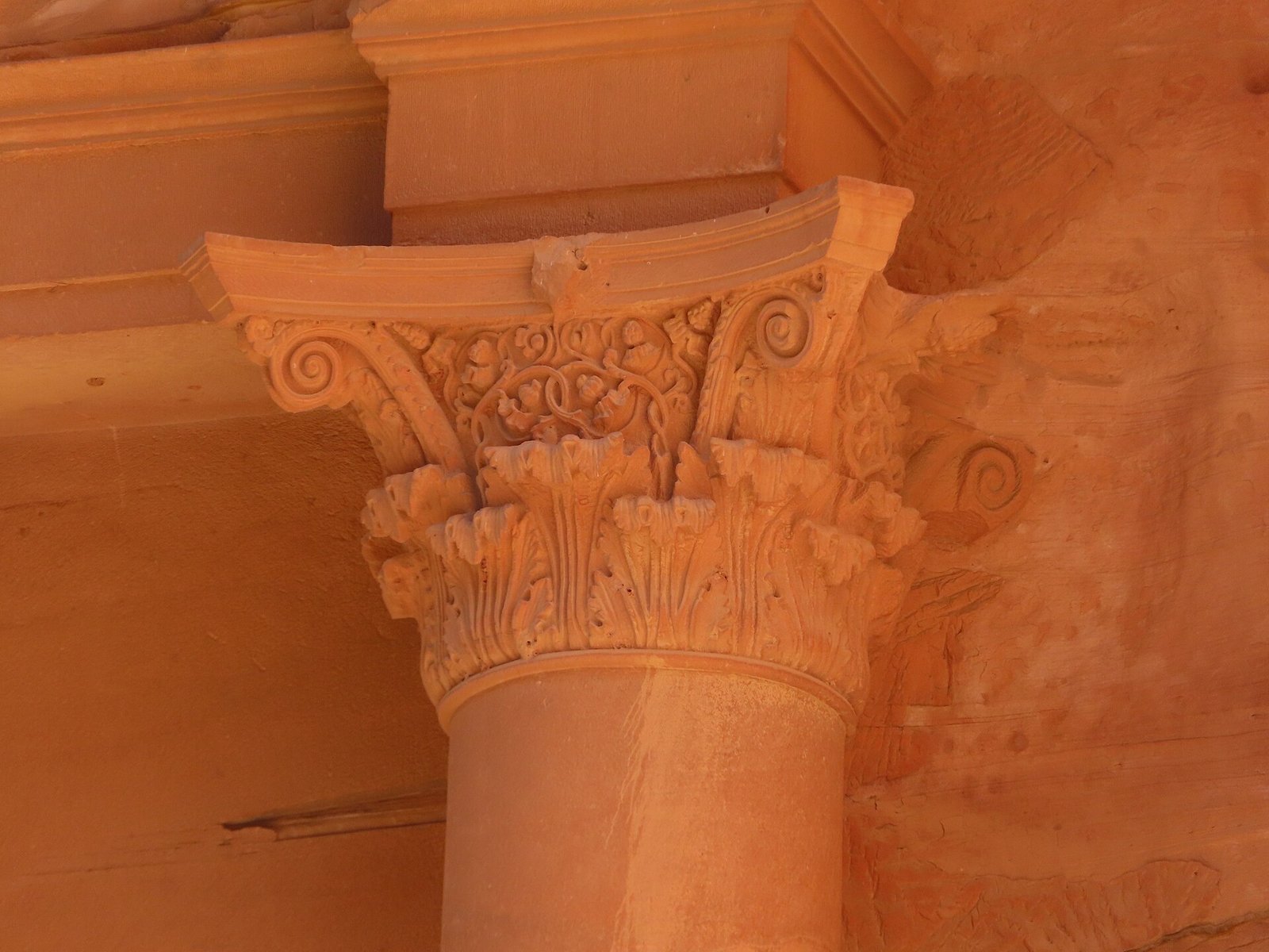 A carved Nabataean capital on the rose-red facade of the Treasury at Petra, the great caravan city of the incense route.