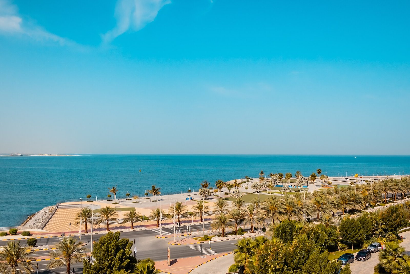 Palm-lined promenade and calm turquoise sea at Al Marjan Island, Ras Al Khaimah.