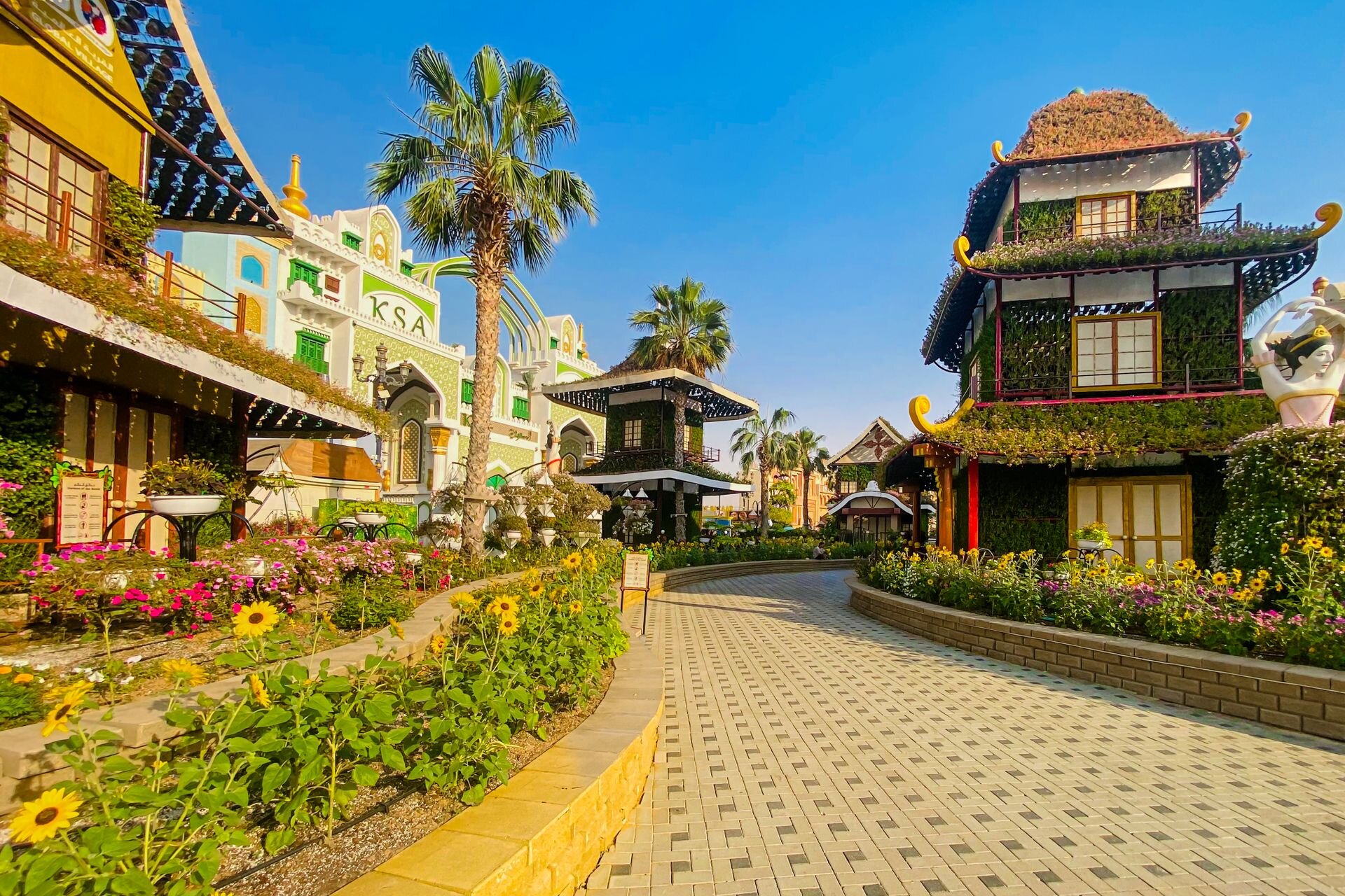 Flower-lined walkways and pavilions at Global Village, Dubai