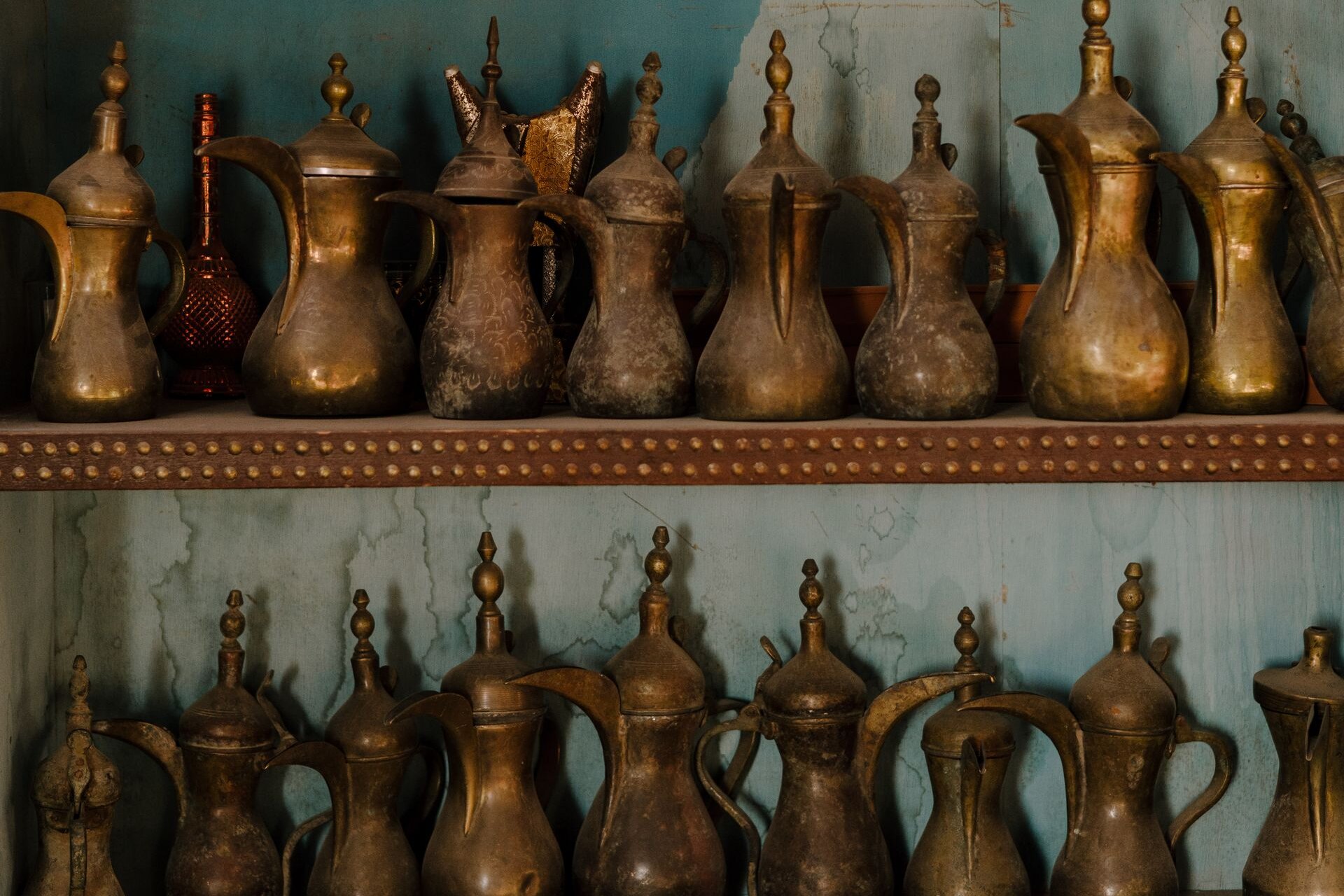 Rows of brass dallah coffee pots, the emblem of Arab hospitality
