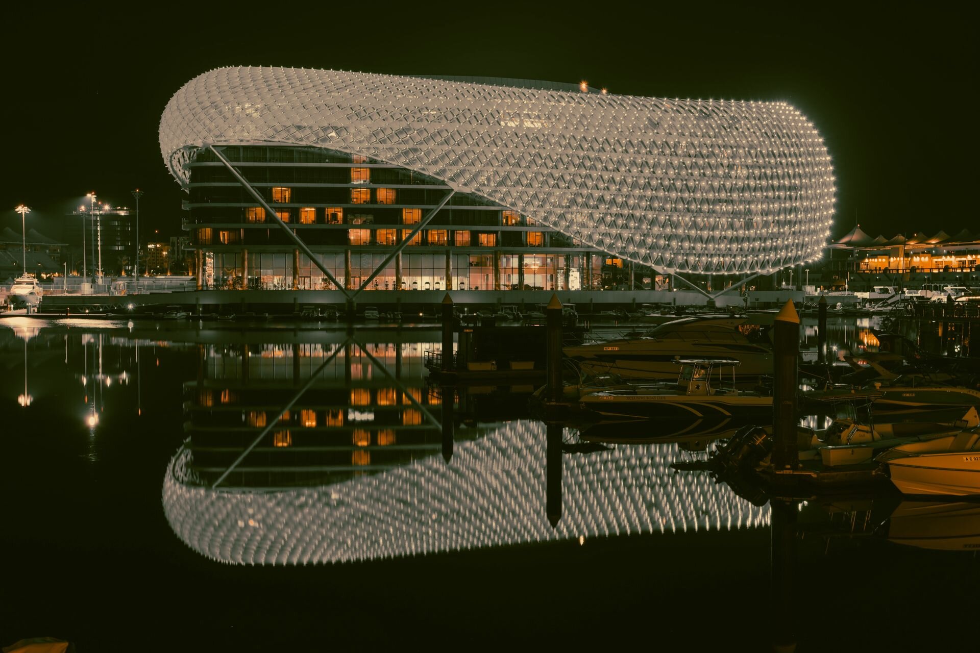 The lattice shell of the W Abu Dhabi Yas Island lit up over Yas Marina