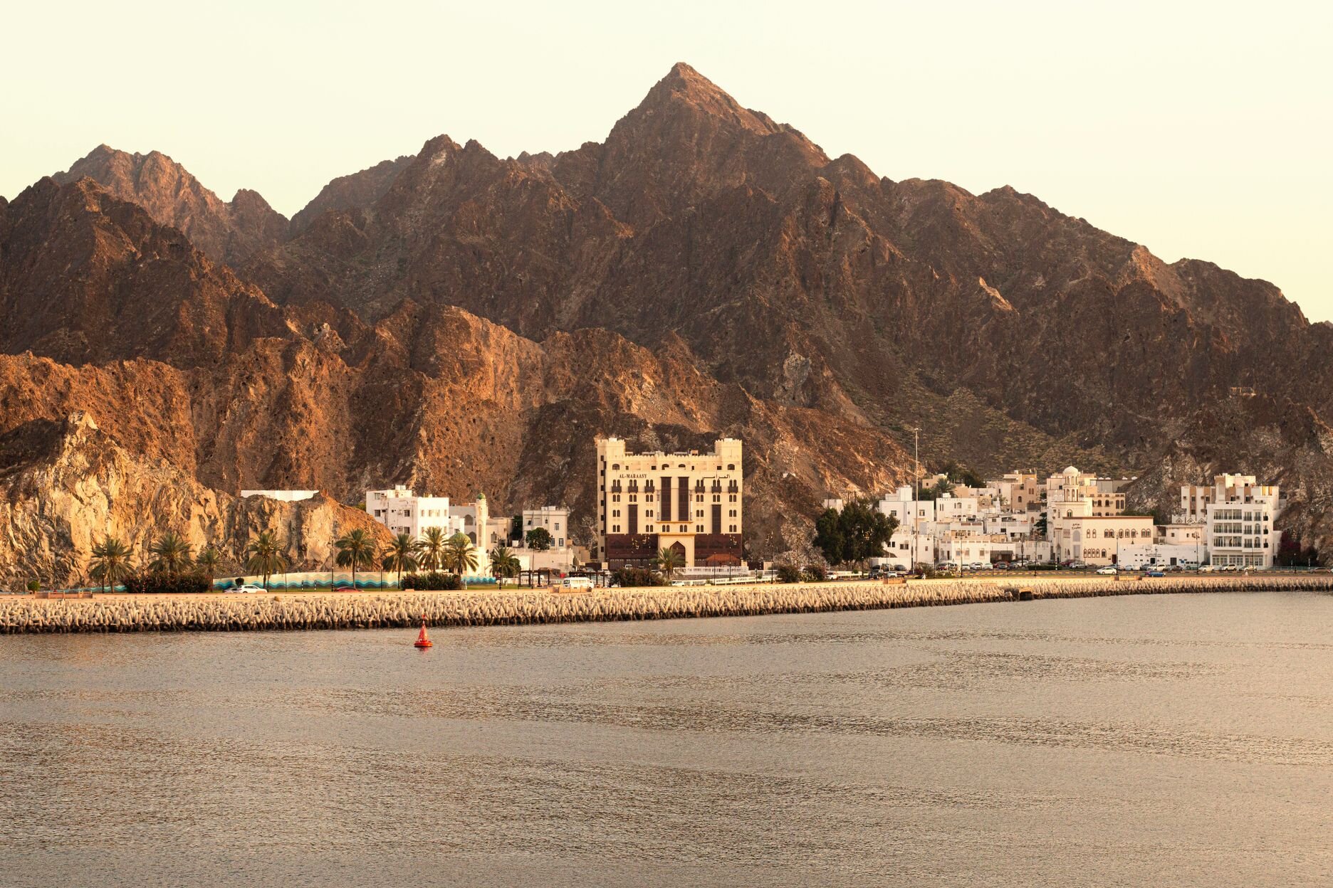 The Mutrah Corniche below the Hajar Mountains at golden hour, Muscat