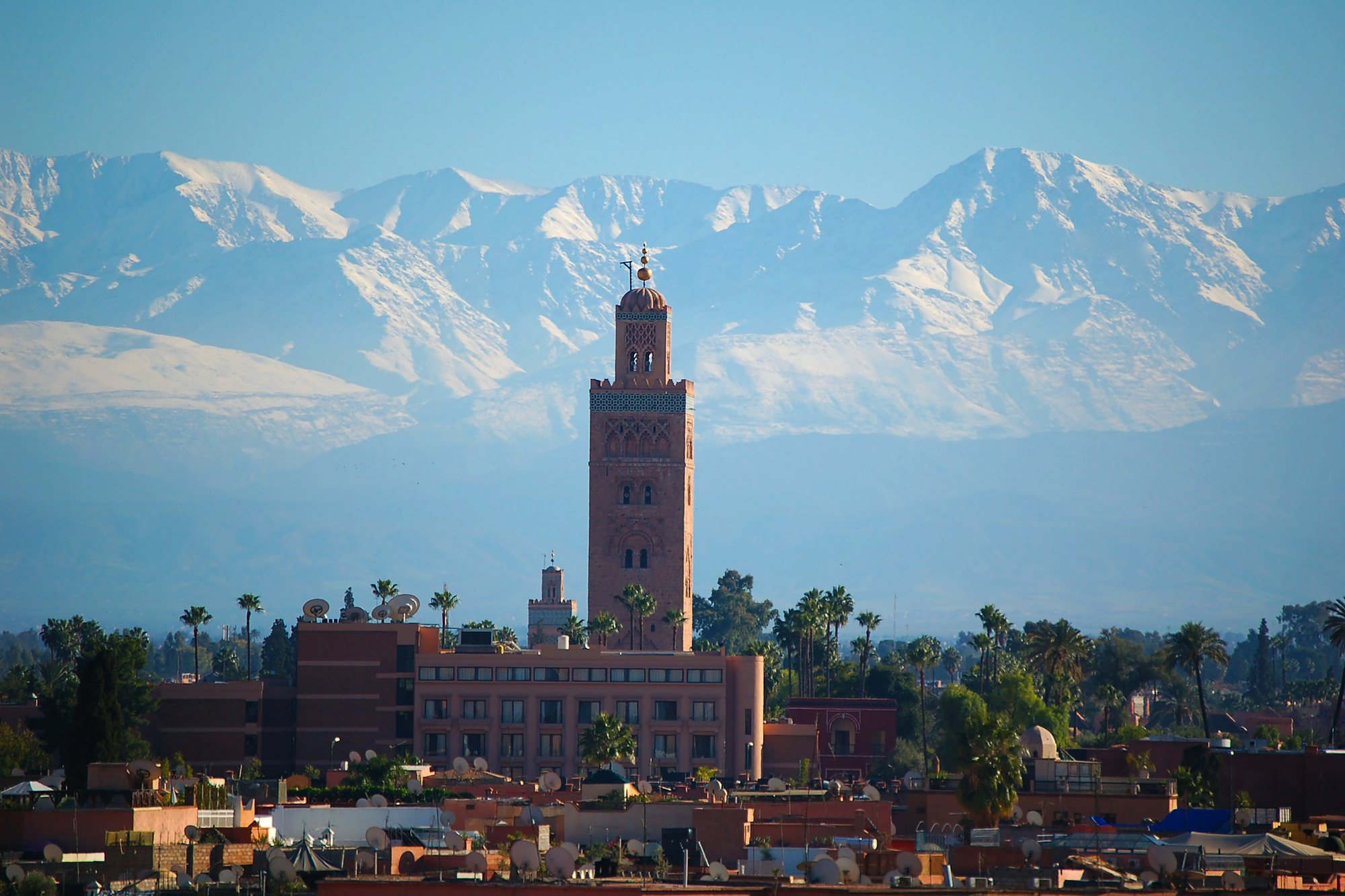 The Koutoubia minaret in Marrakech with the snowy Atlas Mountains