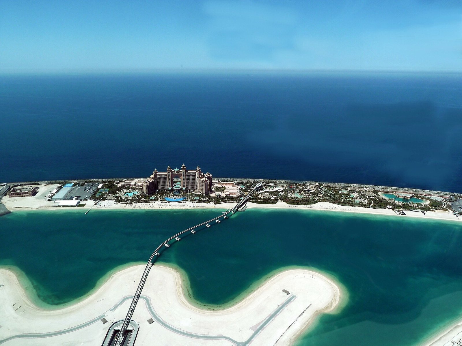 Atlantis The Palm stands at the crest of the Palm Jumeirah, its crescent breakwater curving into the turquoise Gulf, Dubai.