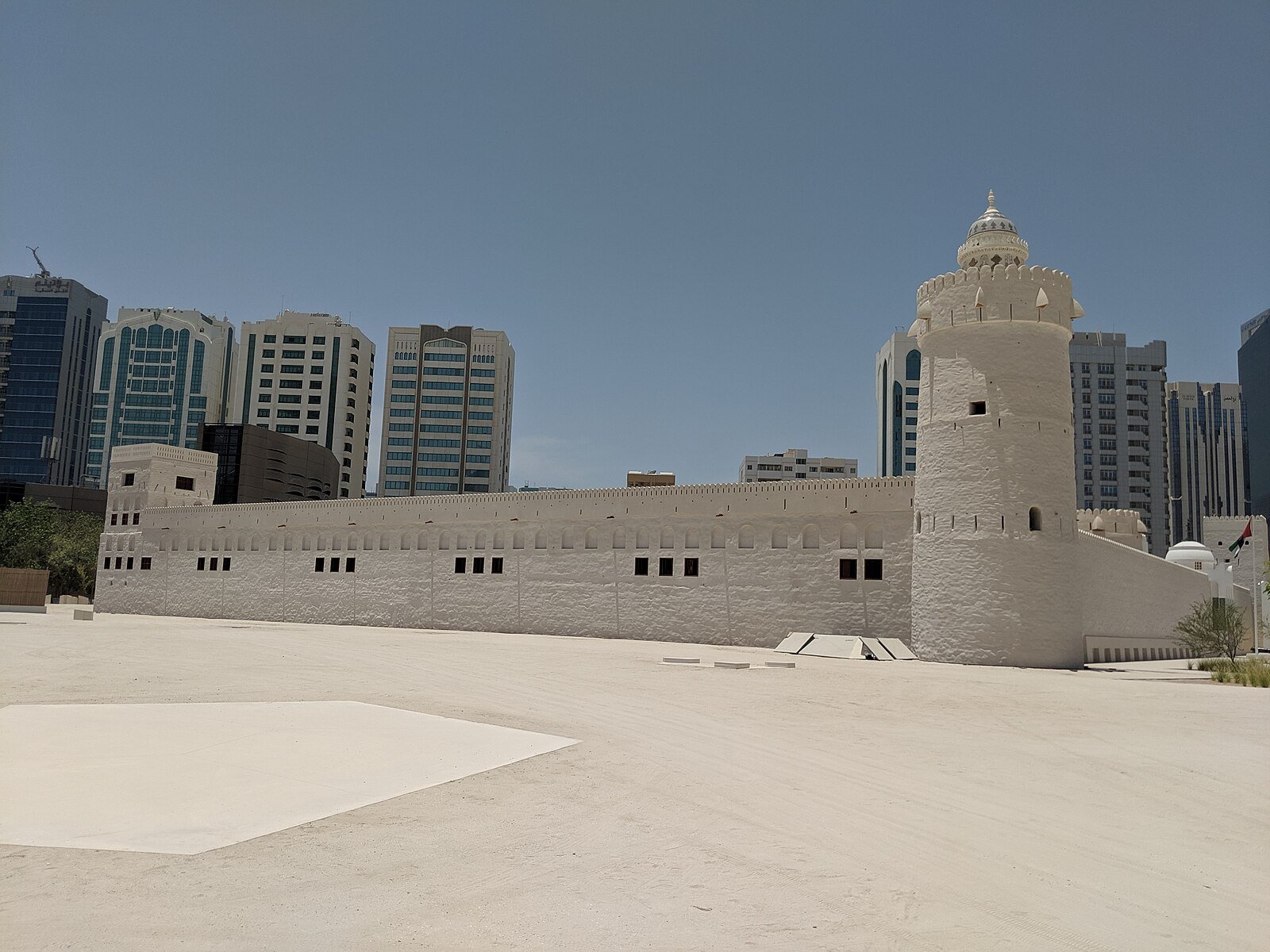 The whitewashed walls and round watchtower of Qasr Al Hosn, the oldest stone building in Abu Dhabi, before the city's modern towers.
