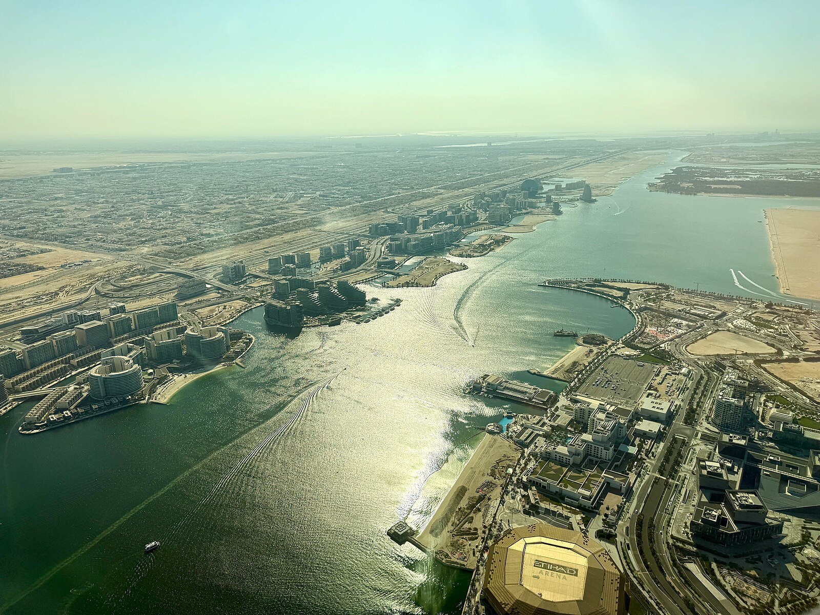 Yas Island and its waterways seen from the air, glinting in the afternoon sun, Abu Dhabi.