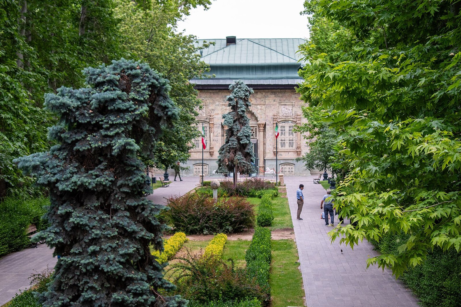 A garden path lined with spruces leads to the Green Palace in the Saadabad palace complex, Tehran.