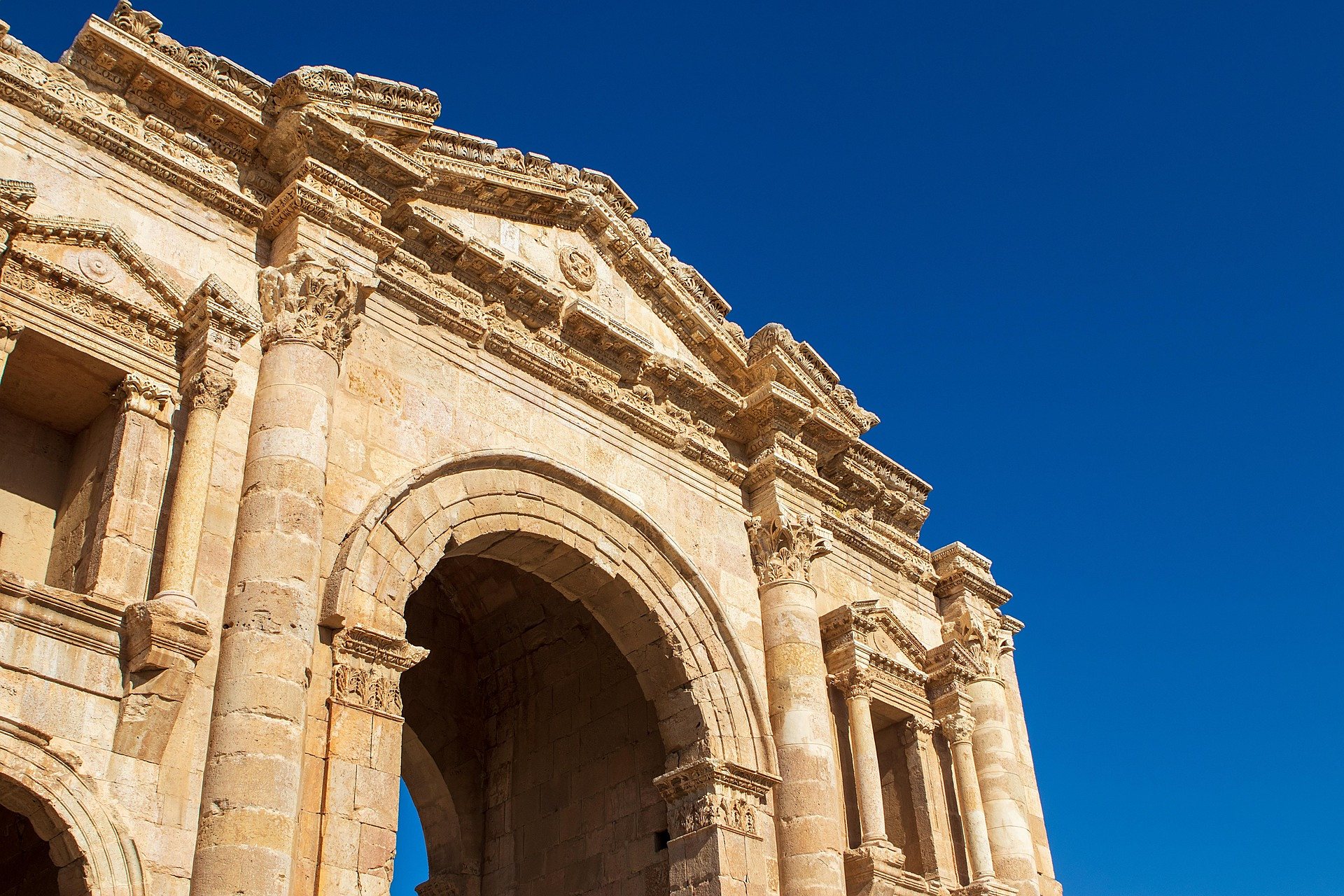 Hadrian’s Arch at the Roman city of Jerash under a deep blue sky