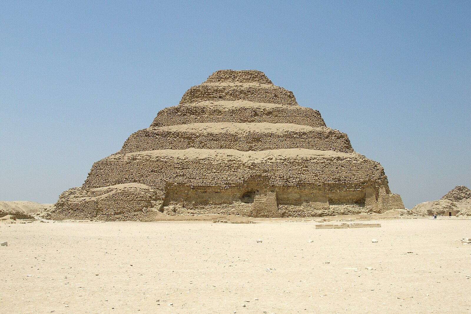 The six stepped tiers of the Pyramid of Djoser rising from the open desert at Saqqara