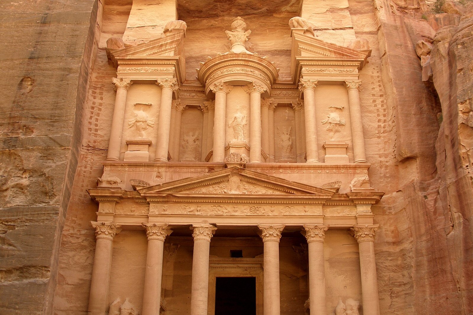 The rose-red facade of Al-Khazneh, the Treasury, carved into the cliffs of Petra, Jordan