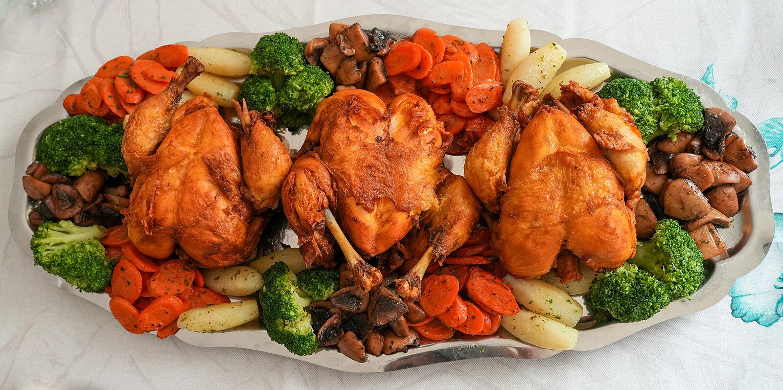 A Moroccan platter of golden chicken with carrots, broccoli, mushrooms and potatoes, served in Rabat.