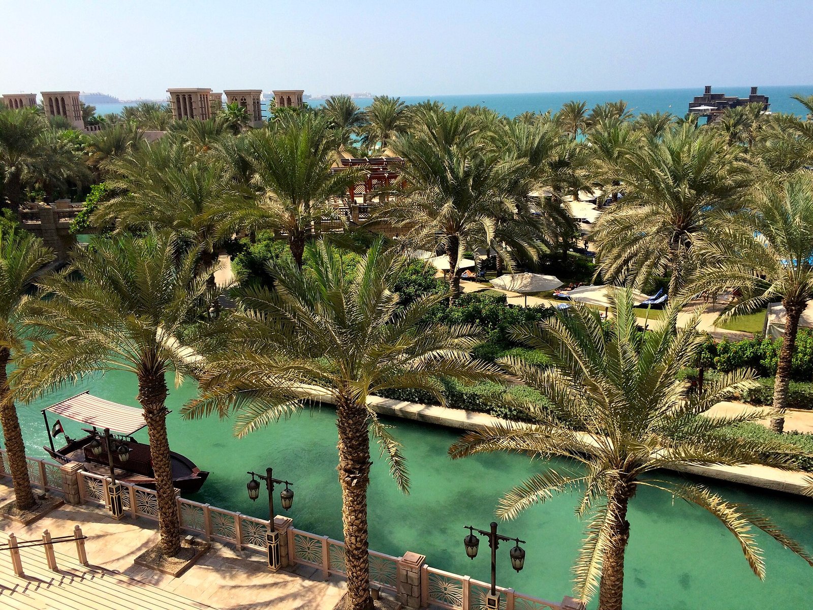 Palm-shaded waterways and gardens winding through the Jumeirah Al Qasr resort at Madinat Jumeirah, Dubai.