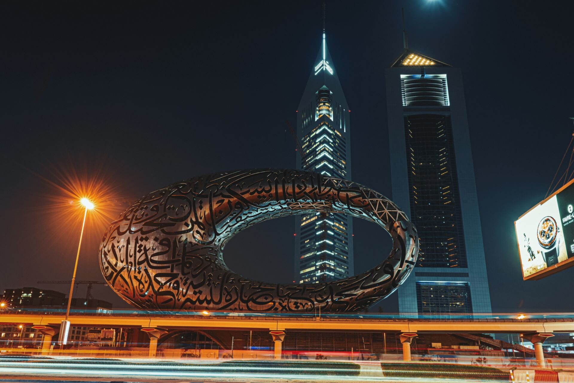 The Museum of the Future at night beside the Emirates Towers, Dubai