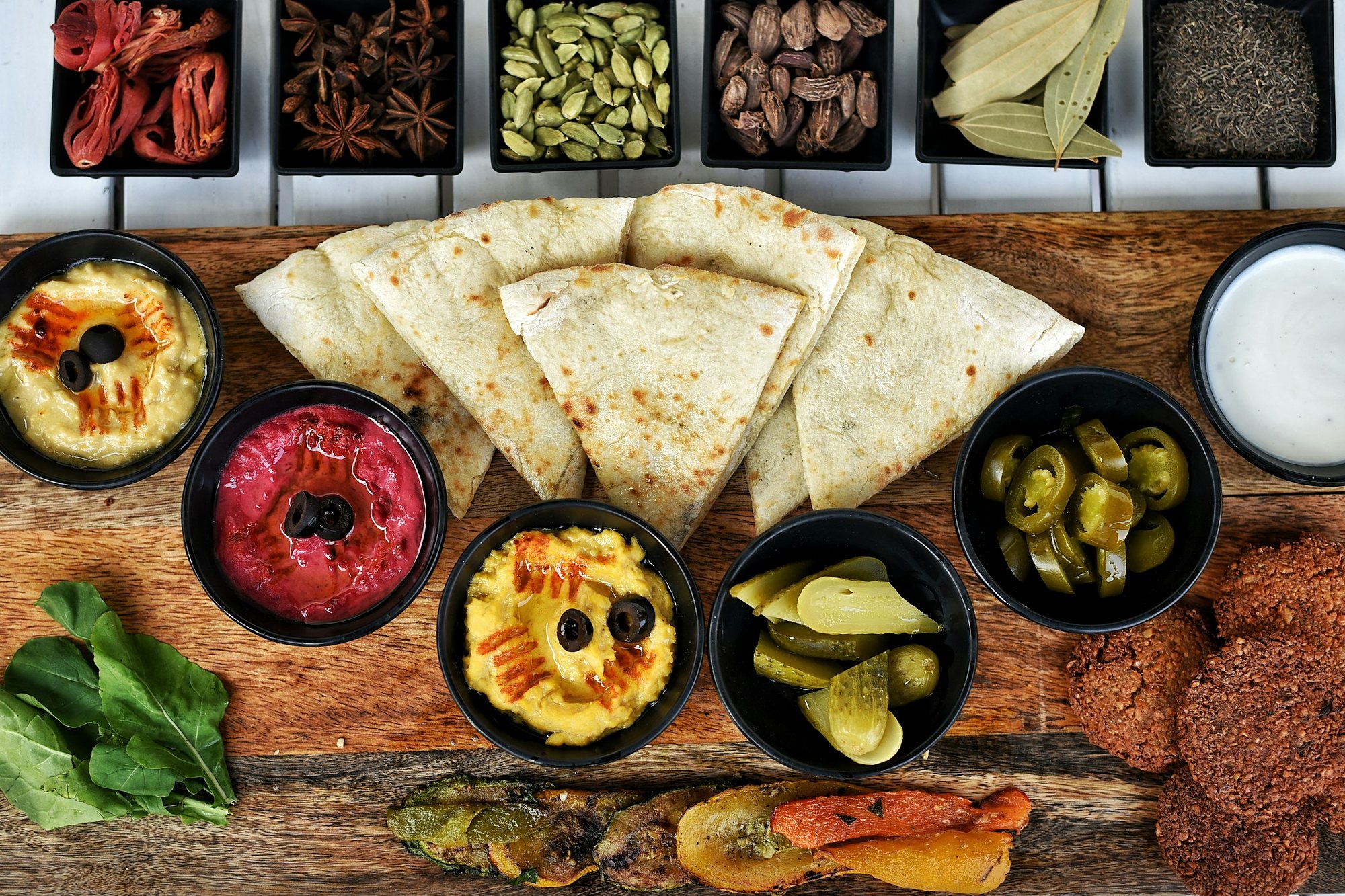 A Levantine mezze board of hummus, beetroot dip, falafel and warm flatbread