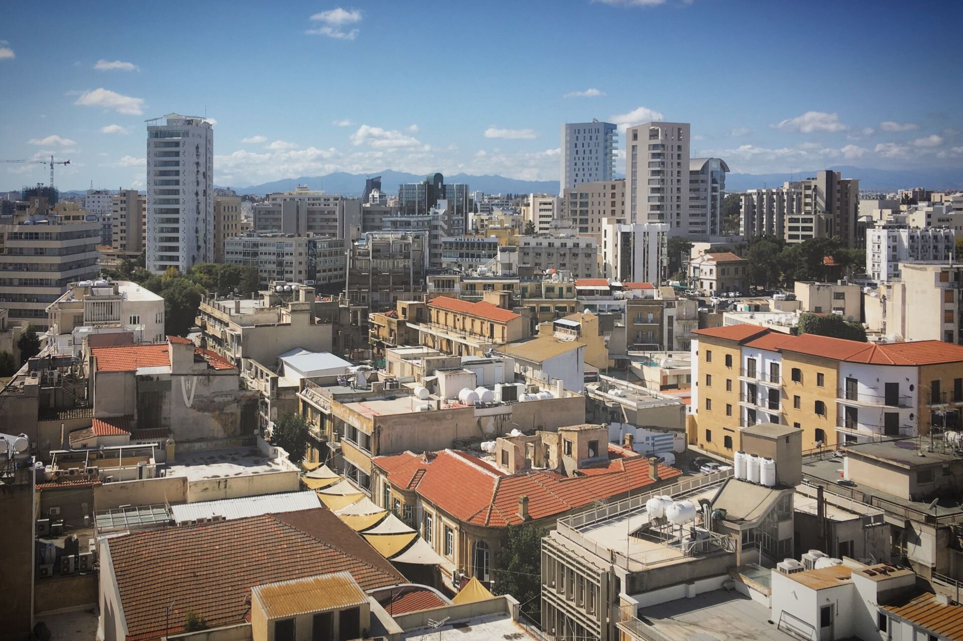 Nicosia's rooftops and new towers, with the Troodos mountains beyond