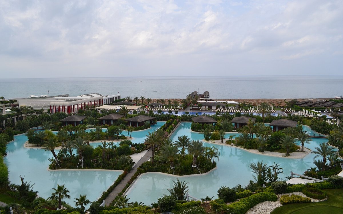 The palm-fringed lagoon pools and beach villas of Maxx Royal Belek stretching to the Mediterranean