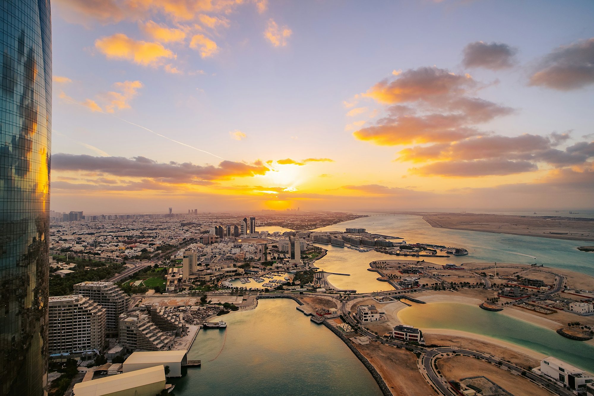 Abu Dhabi and its waterfront at sunset, seen from above