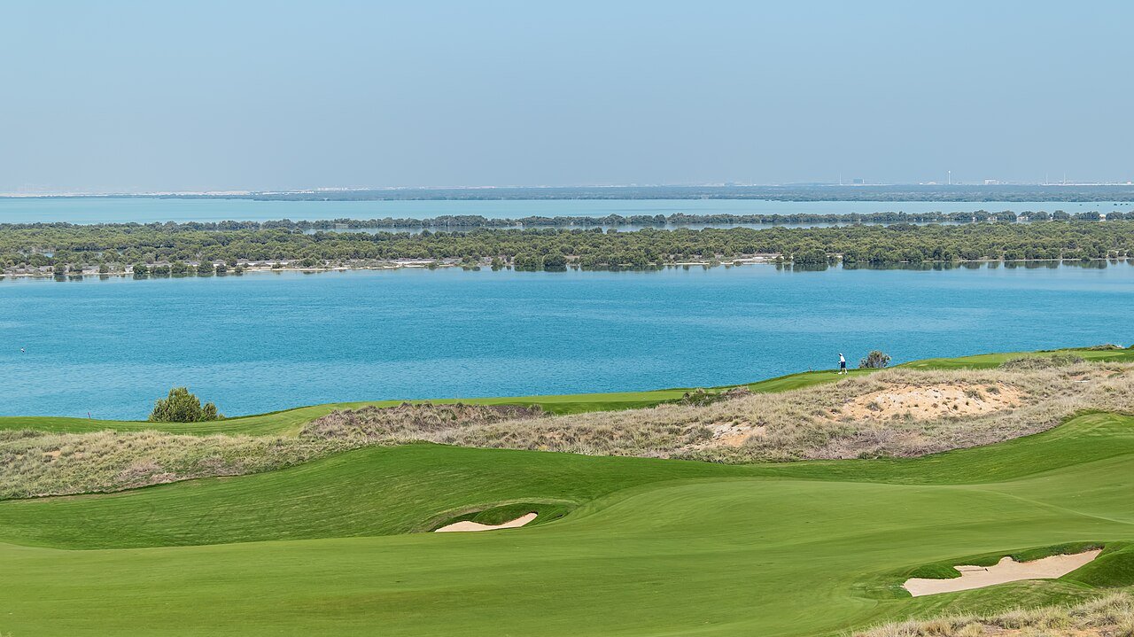 A links fairway and bunkers running down to the blue waters of the Gulf at Yas Island, Abu Dhabi.