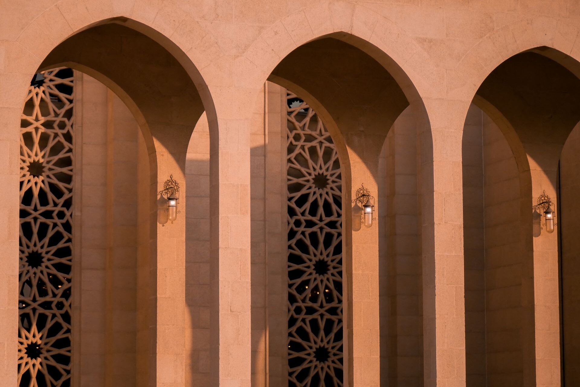 Pointed arches with star-pattern lattice in warm evening light