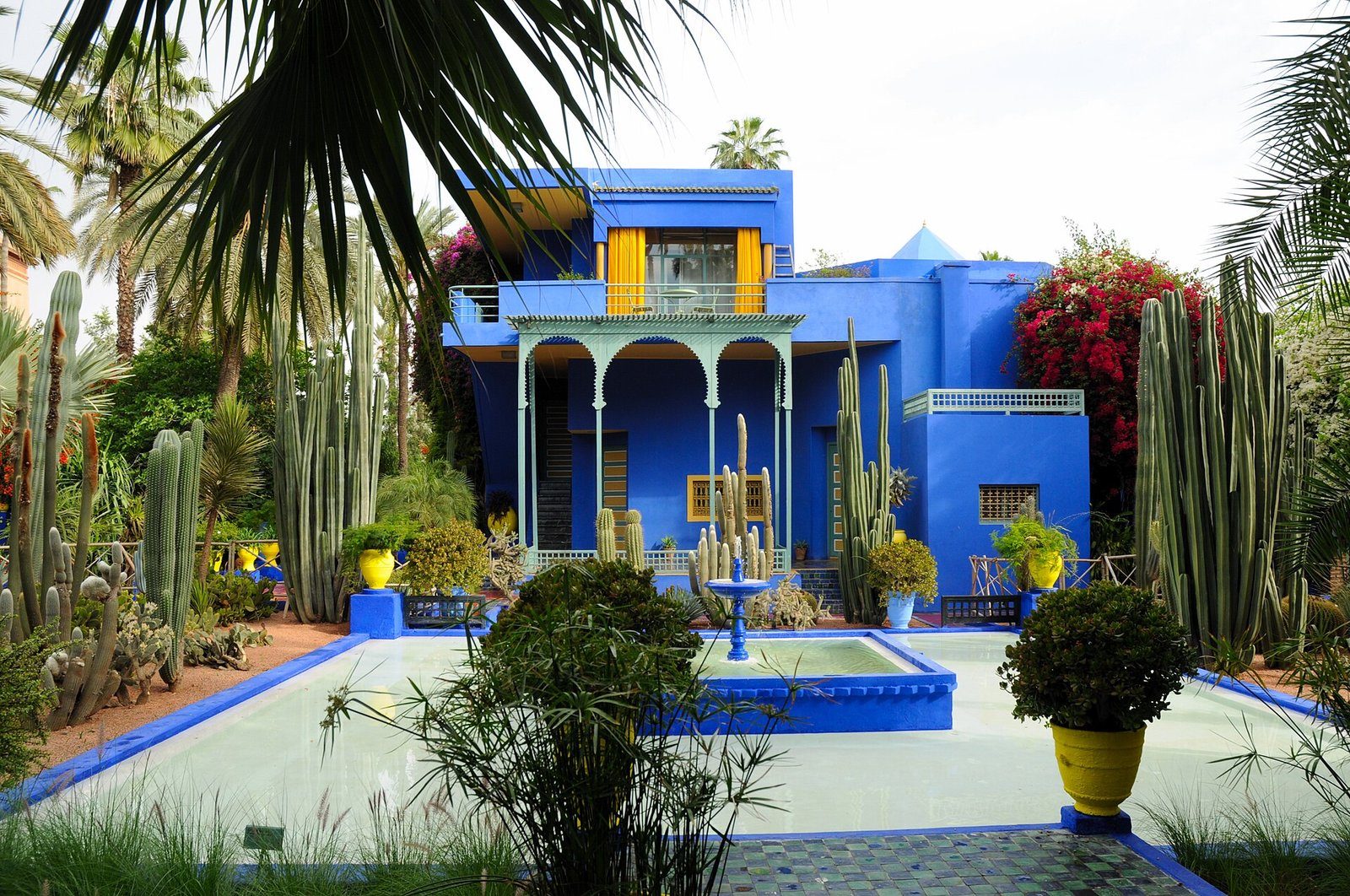 La villa azul cobalto, los cactus y el estanque con fuente del Jardin Majorelle en Marrakech