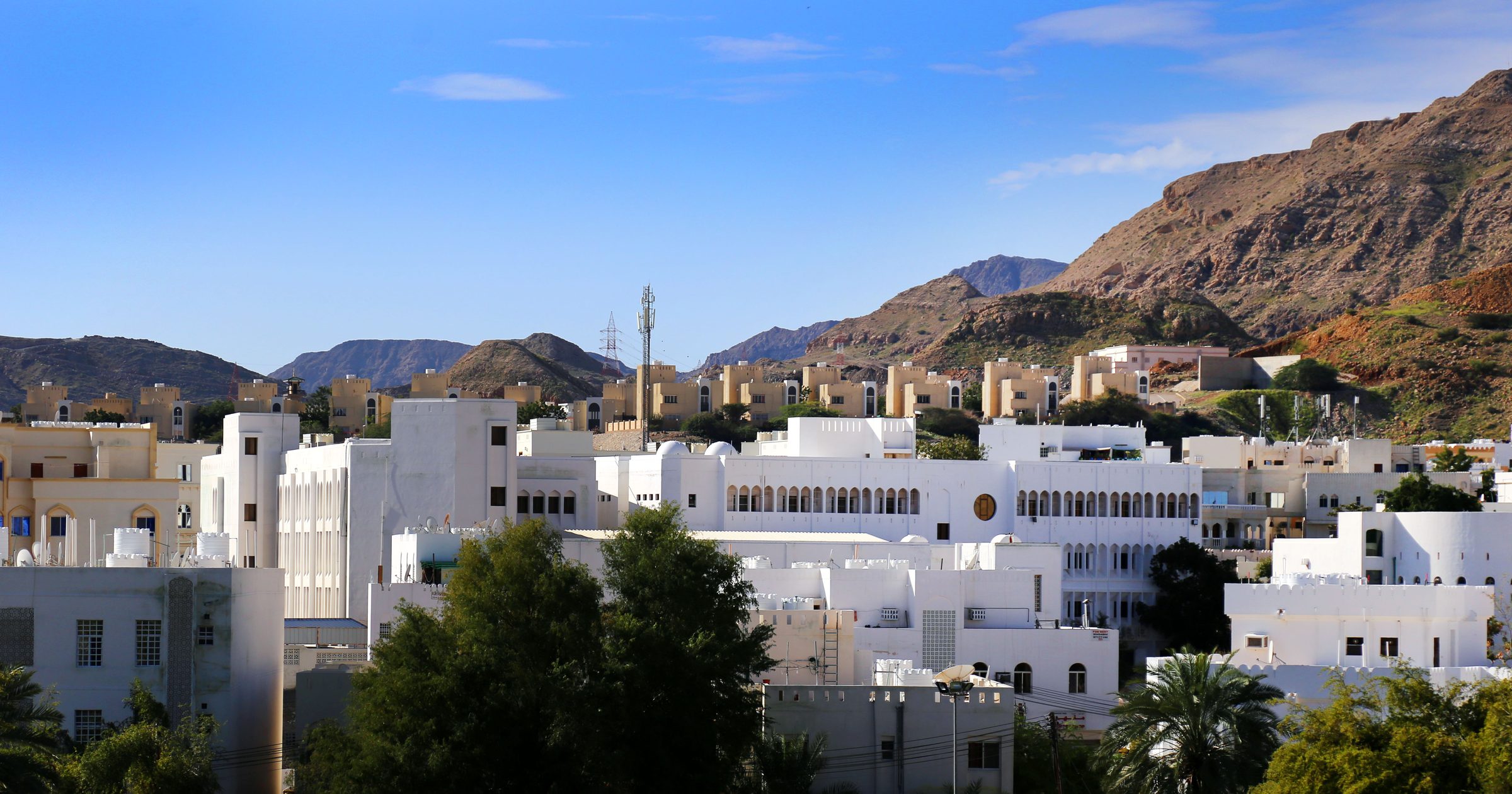 Villas blancas de Mascate con las montañas de Hajar como telón de fondo