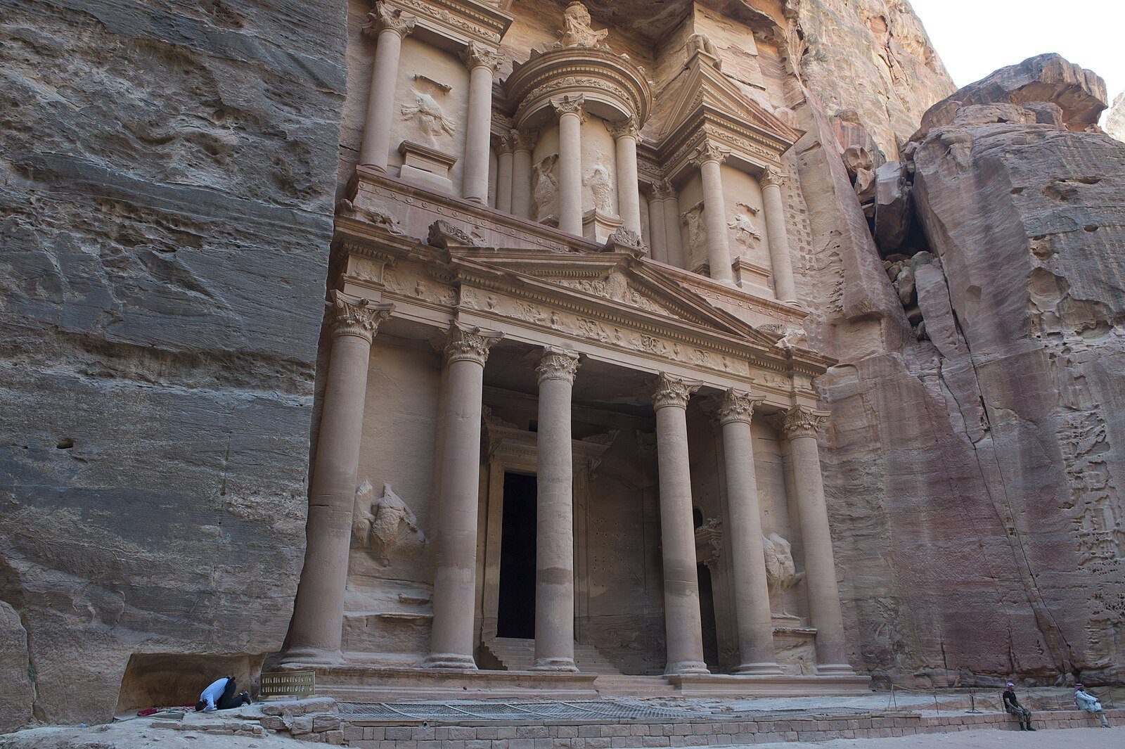 La fachada de color rosa rojizo de Al-Khazneh, el Tesoro, enmarcada por las paredes de arenisca del Siq en Petra.